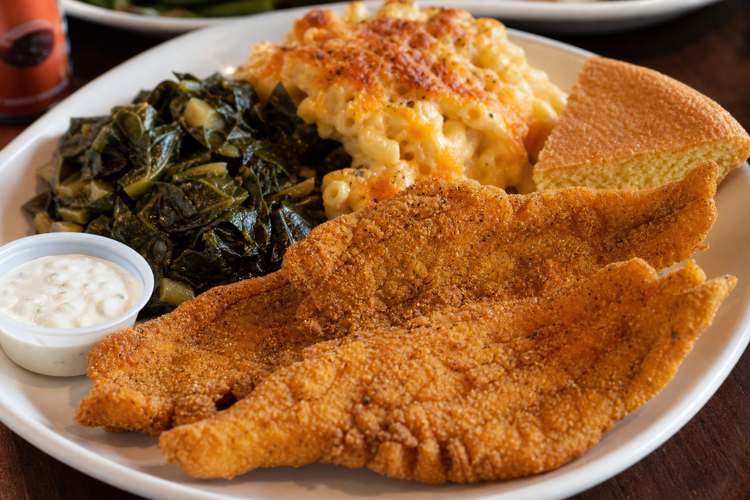 Fried catfish plate with mac and cheese and collard greens