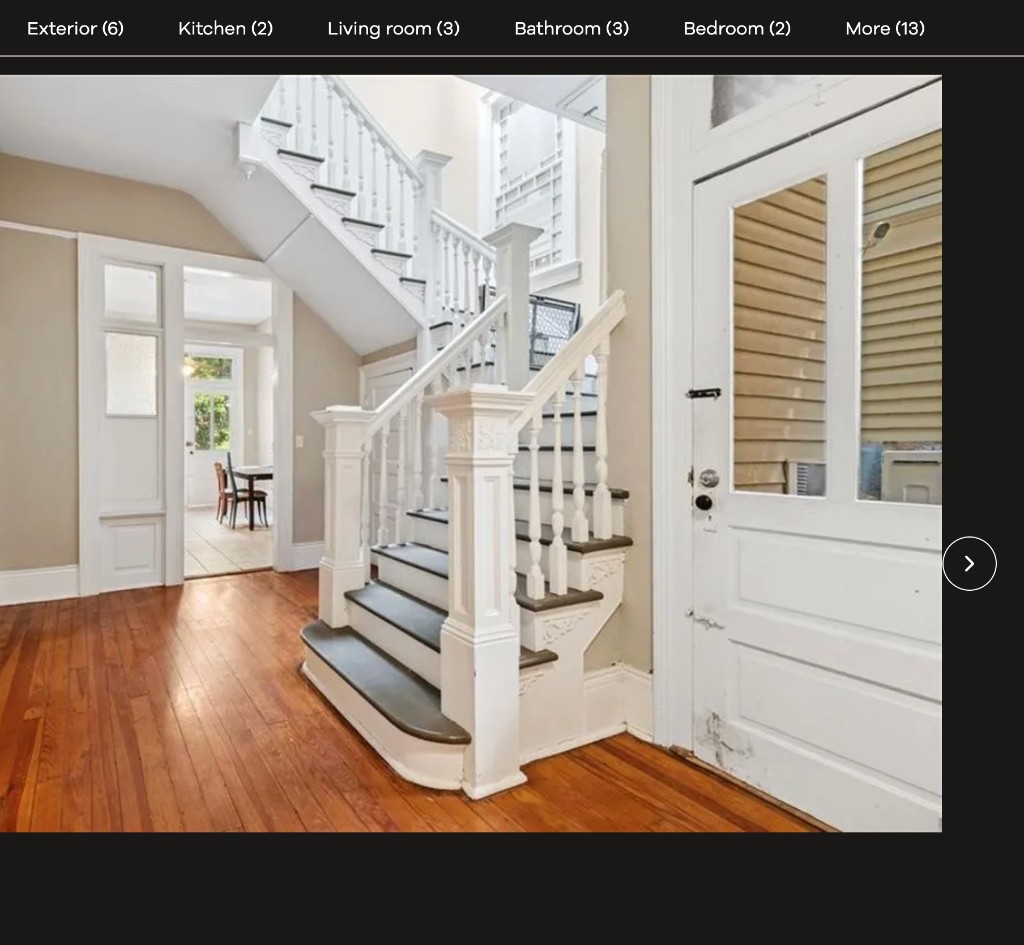 Stair hall with wide opening to dining and side door